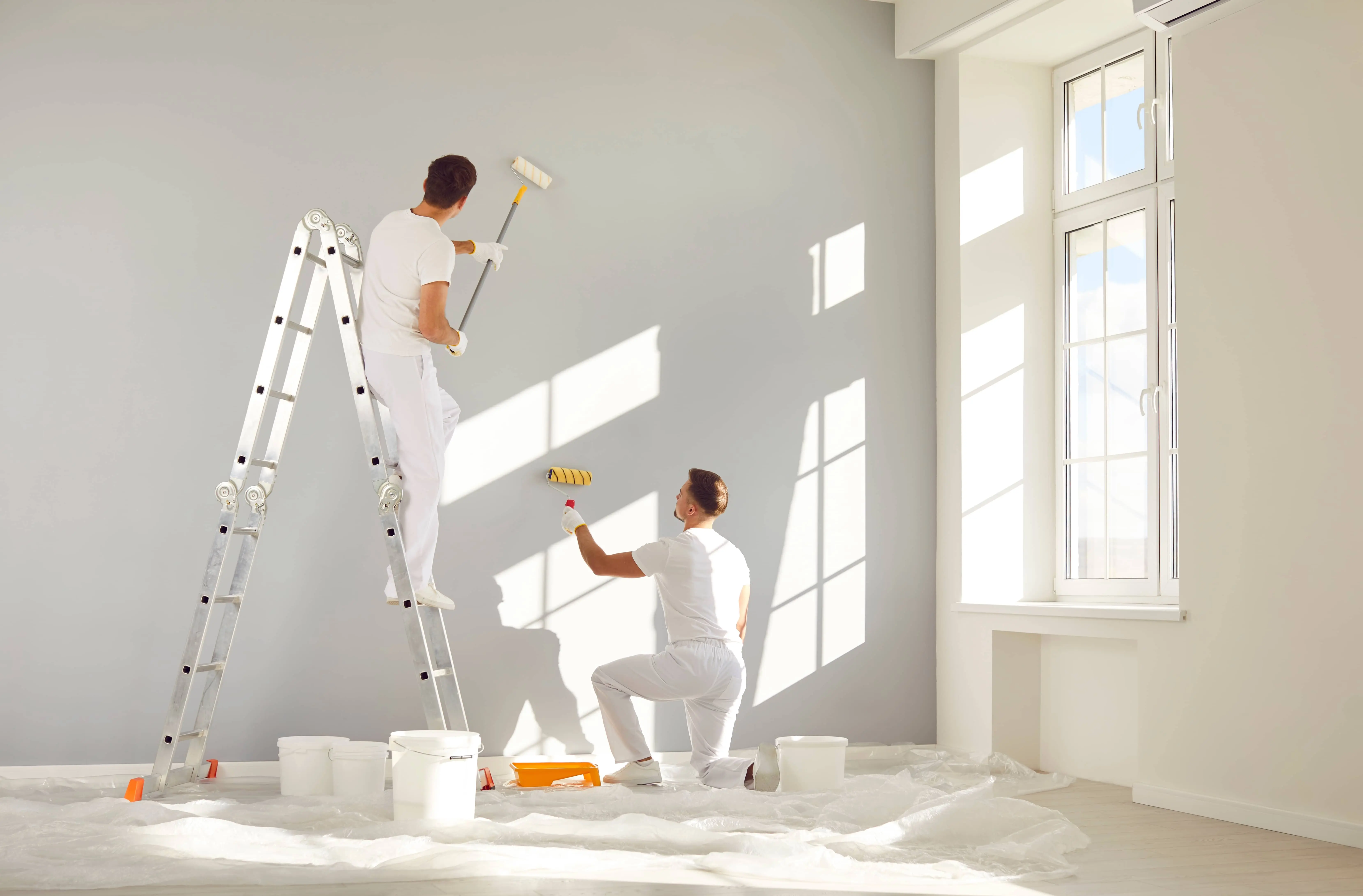 Team painting wall white